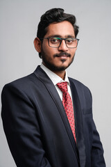 Successful Young indian business man posing over white background