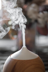 Modern oil aroma diffuser close up on a blurred background.
