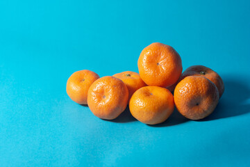 small mandarin oranges with blue backgrounds