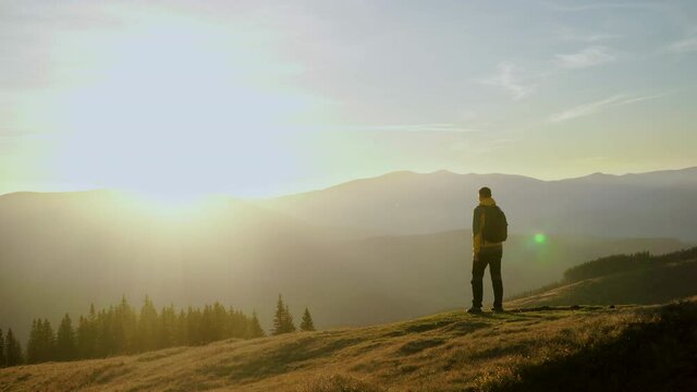 A man travels in the mountains. Beautiful nature of the Carpathian mountains. The concept of travel and active lifestyle. 4K