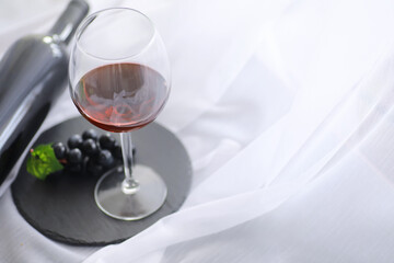 Glass with grape red semi-dry wine. Valentine's day concept background. Gift for the holiday. Sweet sparkling wine.