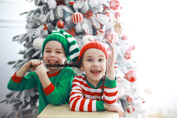 Santa Claus sitting with little cute elves over Christmas background. Time of miracles. Gifts from Santa Claus.