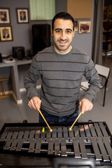 man playing metal xylophone percussion musical instrument