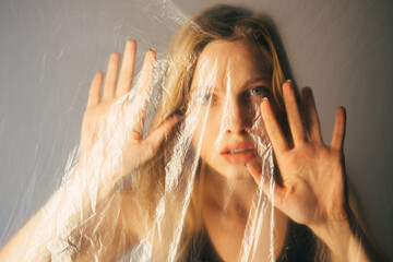 Domestic violence. Defocused art portrait. Female rights. Social isolation. Scared trapped woman...