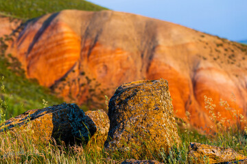 Big Bogdo mountain. Red sandstone outcrops on the slopes sacred mountain in Caspian steppe Bogdo -...