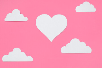 Heart and clouds cut from paper. Flatlay, pink festive background. Valentine's Day concept, love poster, greeting card.