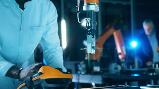Robot is relocating a microchip while being managed by a researcher