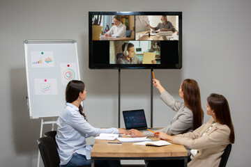Meeting. Young women talking, working in videoconference with colleagues, co-workers at office or living room. Online business, education during insulation, quarantine. Work, finance, tech concept.