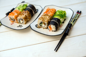 Several sushi on a white plate standing on a white background
