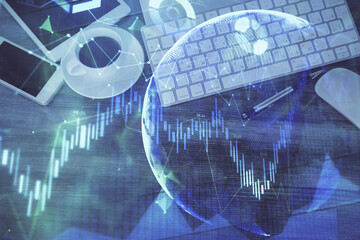 Double exposure of forex chart hologram over desktop with phone. Top view. Mobile trade platform concept.