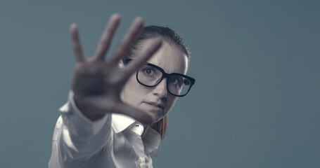 Confident woman making a stop gesture