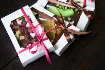 Handmade chocolate in gift boxes, assortment with dried fruits ,  berries and  nuts