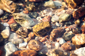 Stones under lake water, with water effect over them