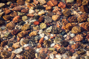 Stones under lake water, with water effect over them
