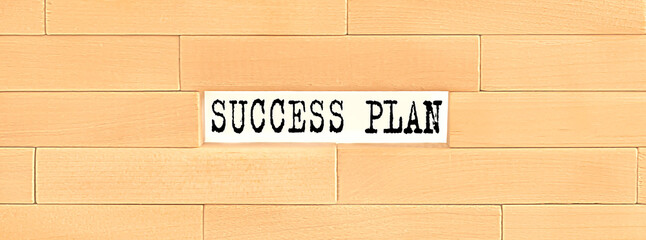SUCCESS PLAN text on the wooden block wall, business