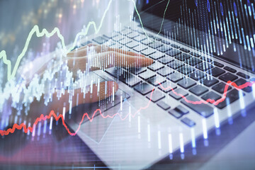 Double exposure of woman hands typing on computer and forex chart hologram drawing. Stock market analysis concept.