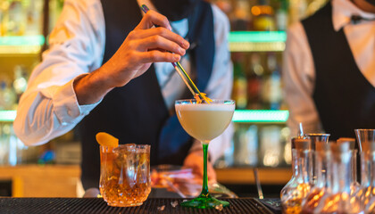 Barman making cocktail at night club