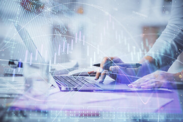 Double exposure of woman hands typing on computer and forex chart hologram drawing. Stock market invest concept.