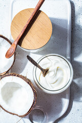 Vegan coconut yogurt in glass jars, white background, top view. Vegan food concept.