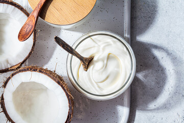 Vegan coconut yogurt in glass jars, white background, top view. Vegan food concept.