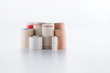 variety of bandages, gauze, cotton and Scotch tap on white background.
