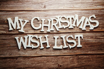 Christmas Wish List alphabet letter on wooden background