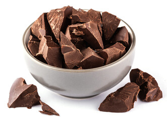 Broken chocolate pieces in a beautiful bowl on a white background