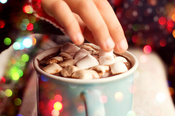 A mug with a warm sweet drink in your hands. the concept of comfort and warmth.