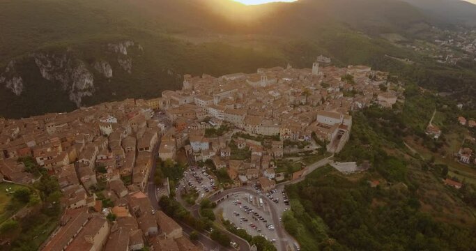 Aerial view over the village of Narni, sunny evening, in Umbria, Italy - tilt up, drone shot
