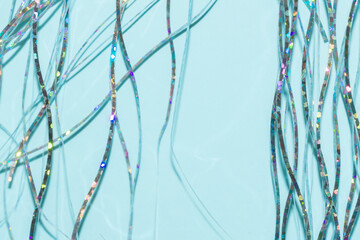 festive holographic tinsel fringe detail on blue background