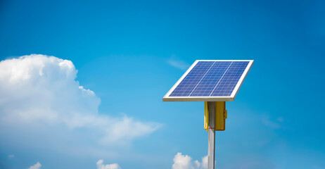 Obraz premium Mini solar cell panel installed in long remote area of Asian countries to store and used the energy from the sunlight with street lamps at night and agricultural area.