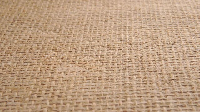 Burlap texture macro shot. Sackcloth fibers in rows. Close up. Dolly Shot