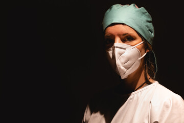 Nurse with surgical cap, surgical gown and pandemic protection mask