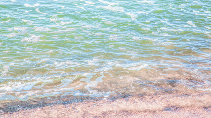 Fototapeta na wymiar crystal clear azure water with sea foam, seascape background