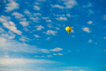 Fototapeta na wymiar Yellow hot air balloon over blue sky background