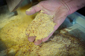one hand controls the whole maize flour during stone milling