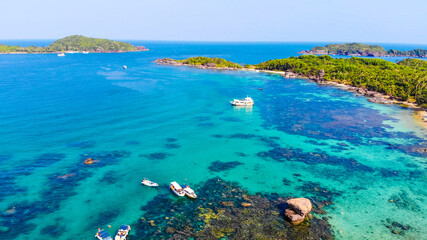 Fototapeta na wymiar Aerial view of beautiful landscape, tourism boats, and people swimming on the sea and beach on May Rut island (a tranquil island with beautiful beach) in Phu Quoc, Kien Giang, Vietnam.