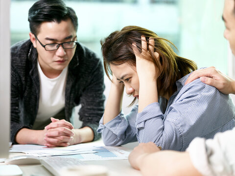 young asian business woman appearing to be frustrated during a discussion in office