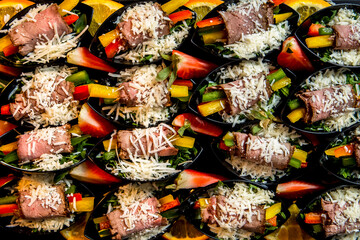 Fototapeta premium Beautifully decorated catering banquet table with different food snacks and appetizers with sandwich