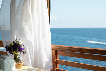 Sea view from an open summer cafe, copy space. Blue water and sky background