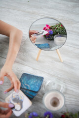 flowers and OH cards by candlelight, self-knowledge at a psychologist's session. divination by Tarot cards