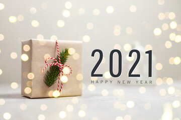 2021 Happy Holidays greeting card. Cozy holiday composition. Gift box decorated a spruce branch and...