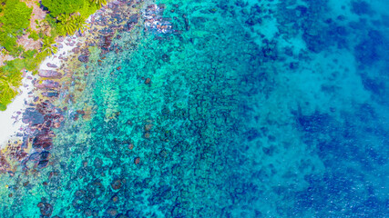 Aerial view of beautiful landscape, tourism boats, and people swimming on the sea and beach on May Rut island (a tranquil island with beautiful beach) in Phu Quoc, Kien Giang, Vietnam.
