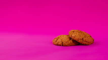 Oatmeal cookies with raisins and nuts inside on a purple background. Delicious homemade cakes made from natural ingredients. Space for text. Wide format view.