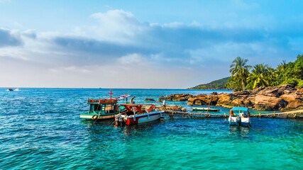 Aerial view of beautiful landscape, tourism boats, and people swimming on the sea and beach on May Rut island (a tranquil island with beautiful beach) in Phu Quoc, Kien Giang, Vietnam.
