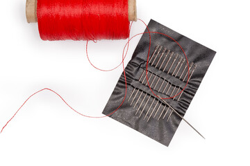 Self-threading hand sewing needles with red thread, top view