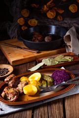 Rustic Snirtjebraten with red cabbage and cucumber
