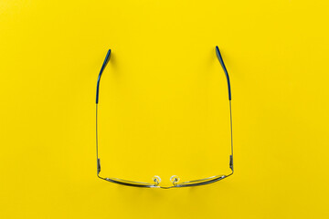 Stylish glasses for correcting vision on a yellow background.