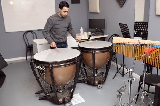 man playing musical instrument orchestral timpani