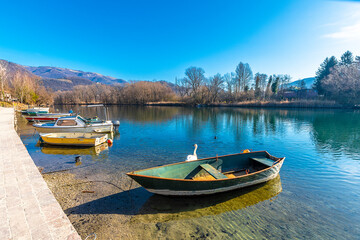 Fototapeta na wymiar Fishing boats on Adda River in Brivio Town of Italy